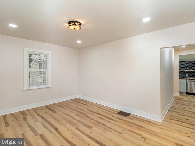 spare room featuring light wood-type flooring