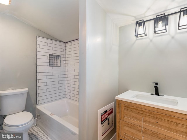 bathroom featuring tile patterned flooring, vanity, lofted ceiling, and toilet