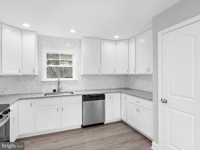 kitchen featuring stainless steel appliances, sink, and white cabinets