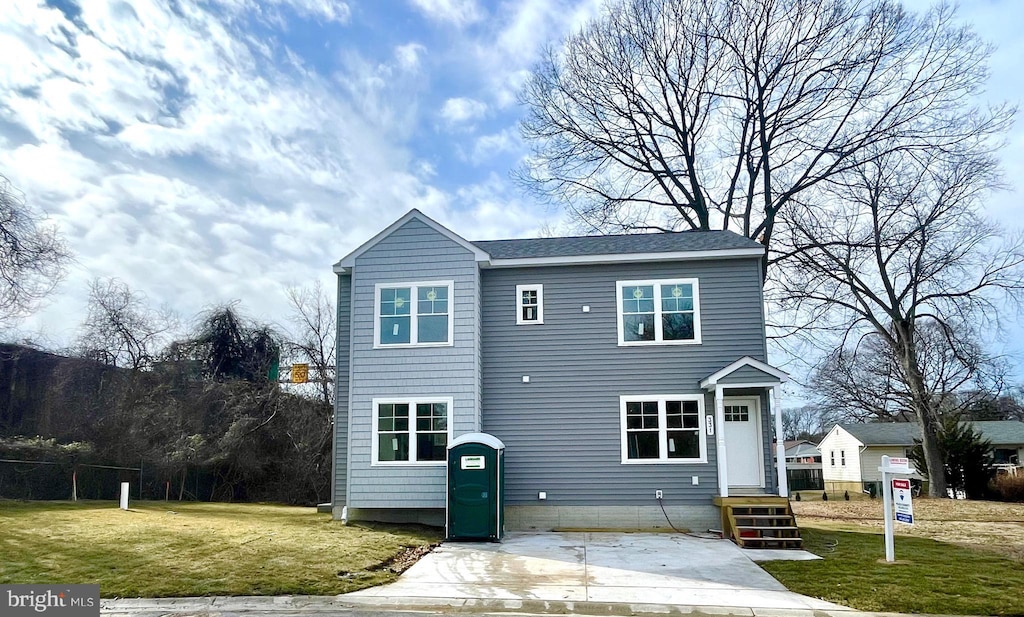 back of property featuring a lawn