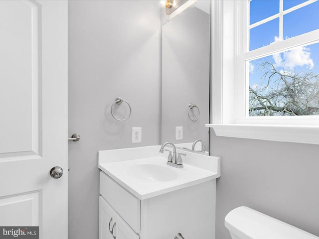 bathroom featuring vanity and toilet