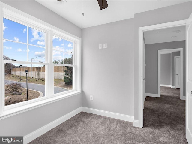 spare room featuring carpet floors and ceiling fan