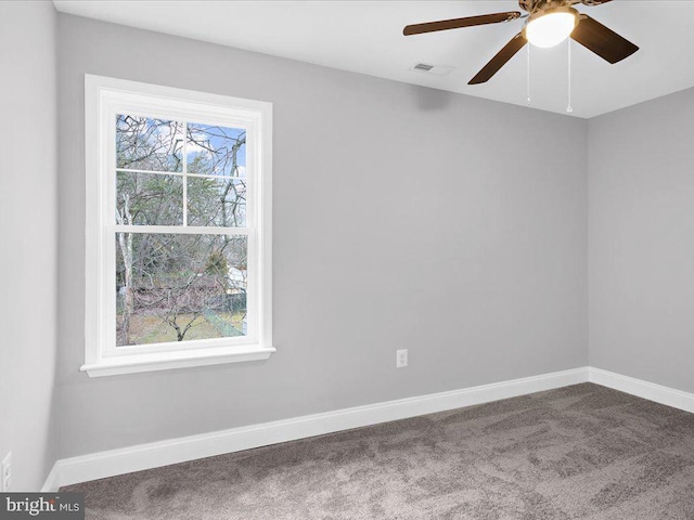 carpeted spare room with ceiling fan