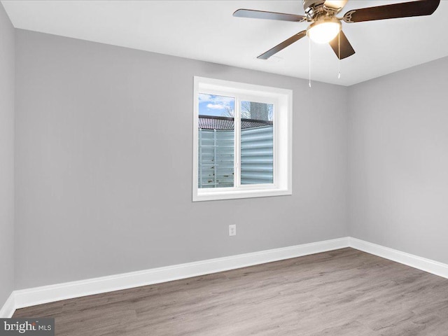 empty room featuring hardwood / wood-style flooring and ceiling fan