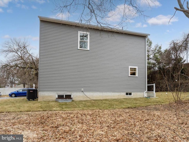 view of property exterior featuring cooling unit and a lawn