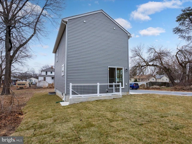 view of home's exterior with a yard