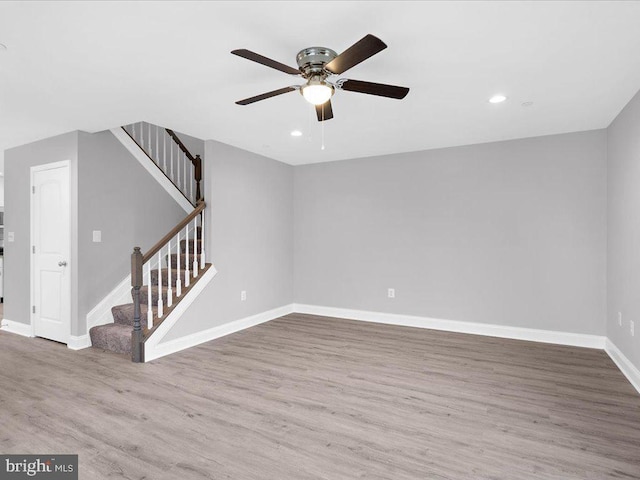 unfurnished living room featuring hardwood / wood-style flooring and ceiling fan