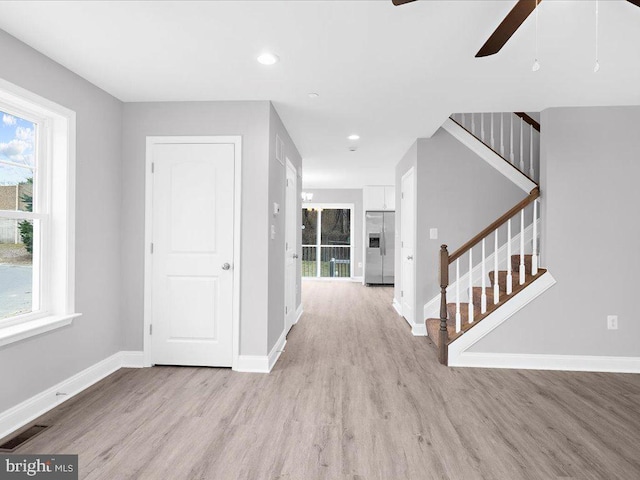 entryway with light hardwood / wood-style flooring and ceiling fan