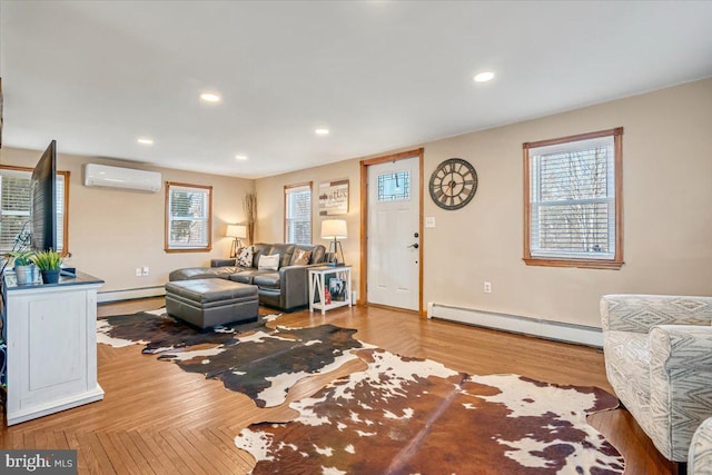 living room featuring wood-type flooring, a wall mounted AC, and baseboard heating