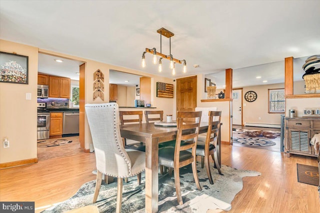 dining room featuring baseboard heating and light wood-type flooring