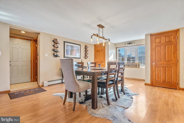 dining area featuring light hardwood / wood-style flooring and a baseboard radiator