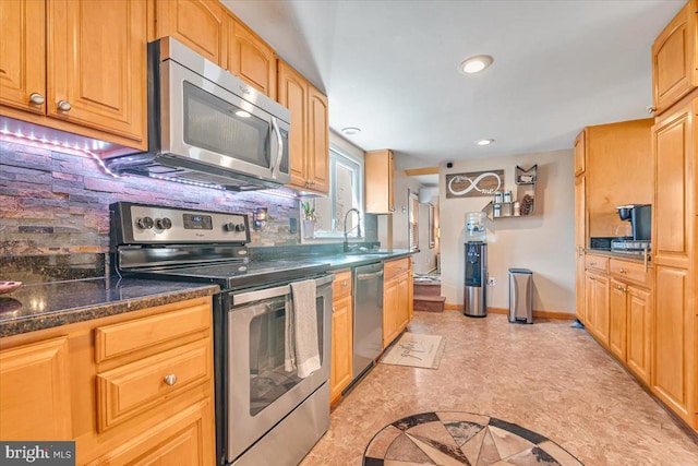 kitchen with tasteful backsplash, sink, and stainless steel appliances