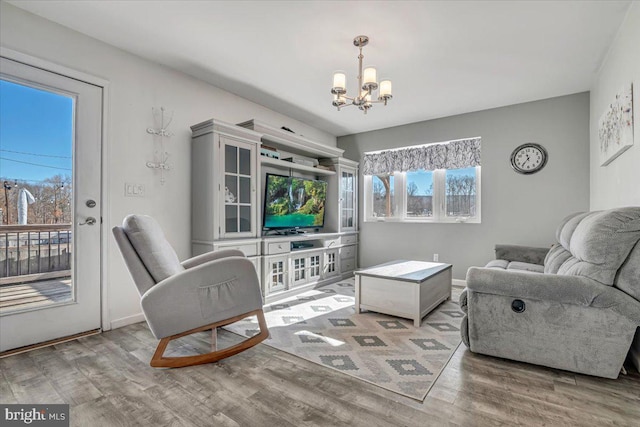 living room with hardwood / wood-style floors and a notable chandelier