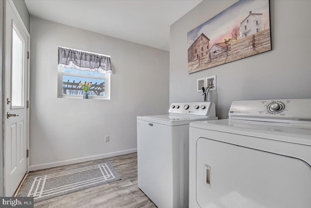 laundry room featuring light hardwood / wood-style floors and washing machine and dryer