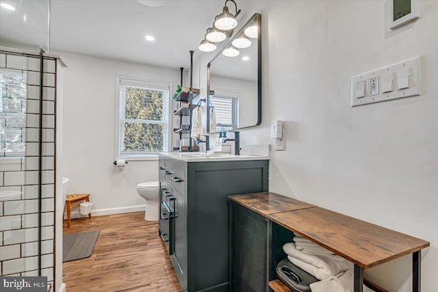 bathroom featuring vanity, hardwood / wood-style floors, and toilet