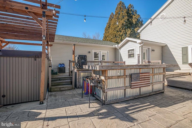 exterior space with a pergola and a hot tub