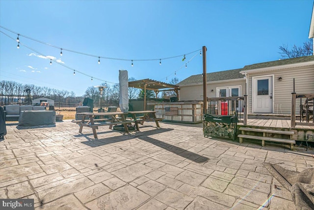 view of patio with a wooden deck, an outdoor living space, and a pergola