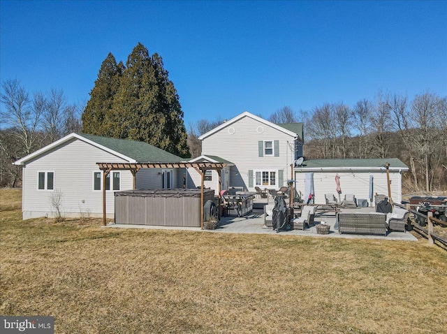 rear view of house featuring a gazebo, a hot tub, a yard, outdoor lounge area, and a patio