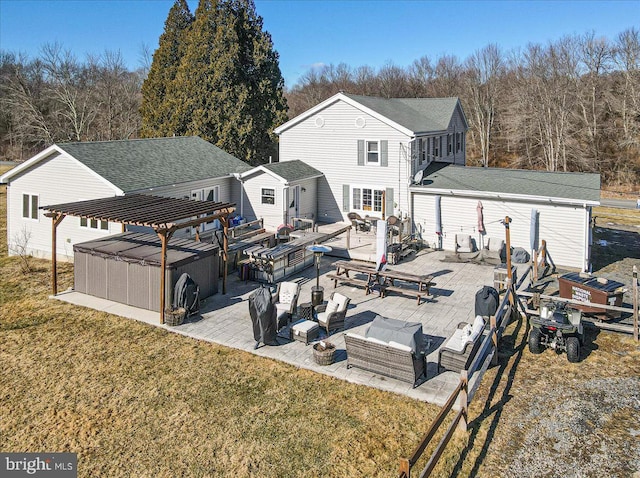 rear view of house with a jacuzzi, a patio area, a lawn, outdoor lounge area, and a pergola