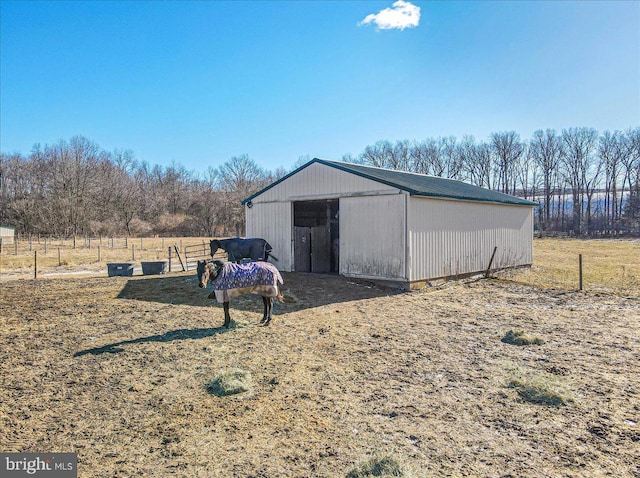 view of outbuilding featuring a yard and a rural view