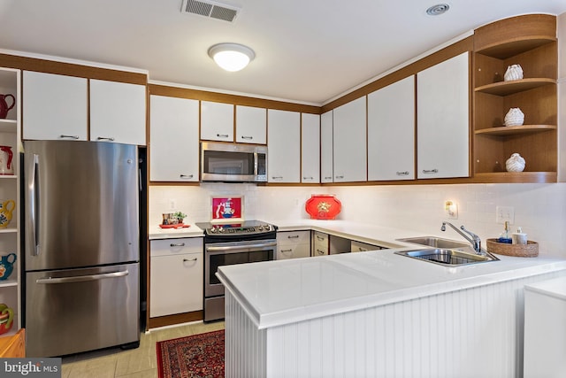 kitchen with light countertops, visible vents, appliances with stainless steel finishes, white cabinets, and a peninsula