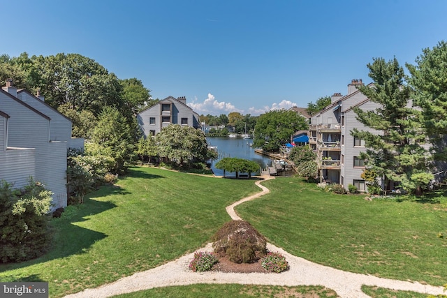 view of property's community featuring a water view and a lawn