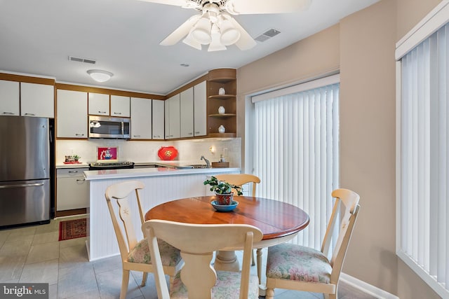 kitchen with light countertops, visible vents, decorative backsplash, appliances with stainless steel finishes, and white cabinetry