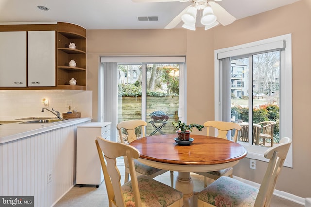 dining area featuring ceiling fan, plenty of natural light, visible vents, and baseboards