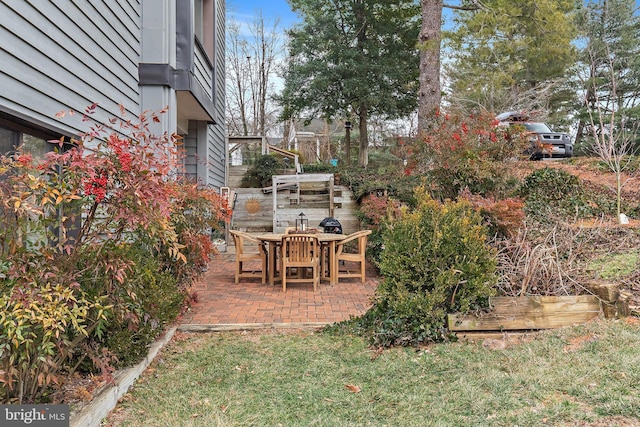 view of yard with outdoor dining space and a patio