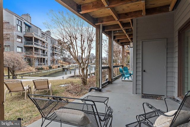 view of patio with a water view