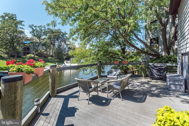 deck featuring a water view and a grill