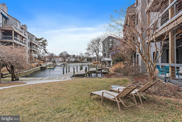 view of dock featuring a yard and a water view