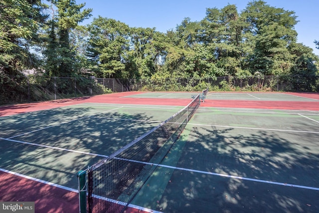 view of tennis court with fence