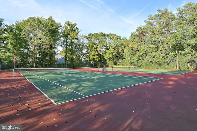 view of sport court featuring fence