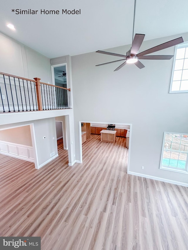 spare room featuring ceiling fan and light hardwood / wood-style floors