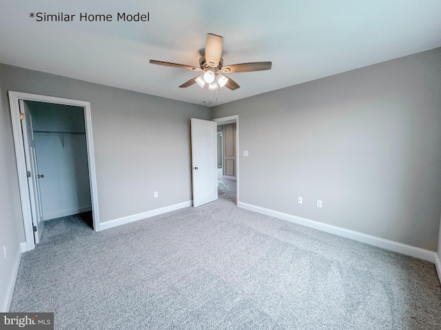 unfurnished bedroom featuring ceiling fan, a closet, and carpet