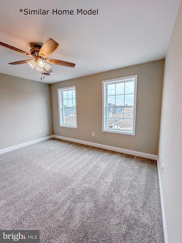 carpeted spare room with ceiling fan