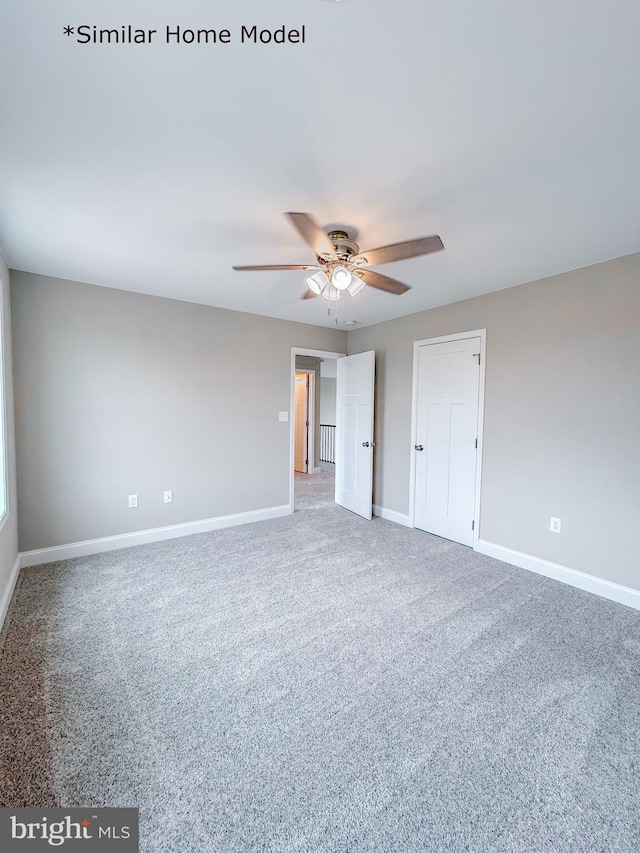 carpeted spare room with ceiling fan