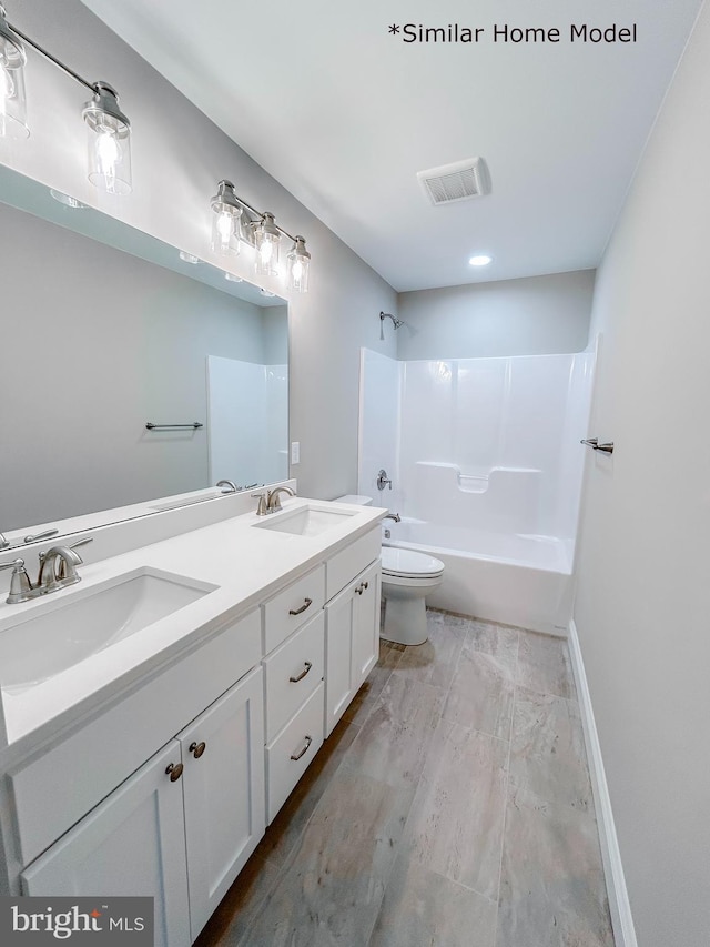 full bathroom with shower / bathtub combination, vanity, and toilet