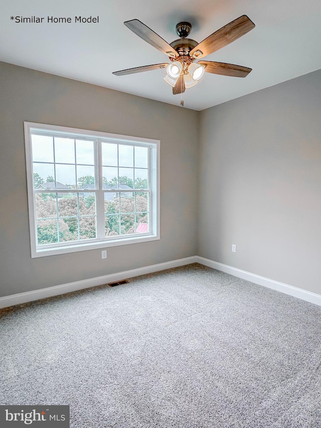 spare room with ceiling fan and carpet floors