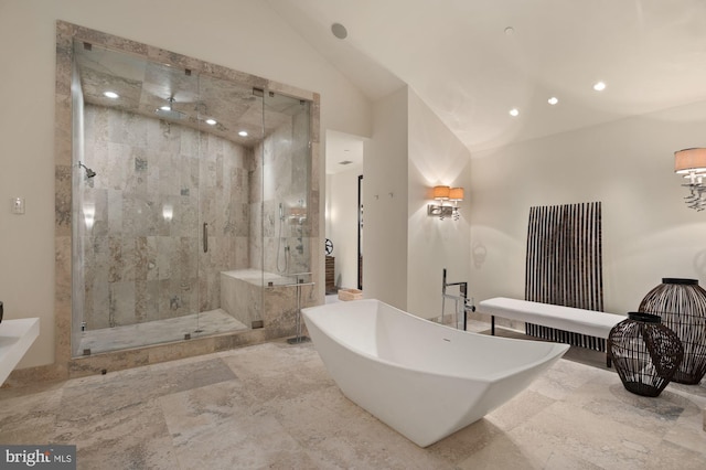 bathroom featuring lofted ceiling and separate shower and tub