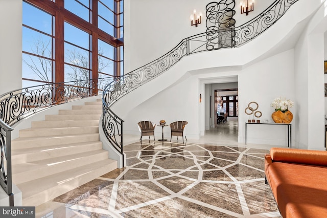 foyer with a notable chandelier and a high ceiling