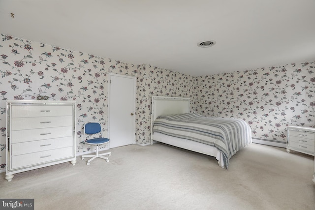 bedroom with a baseboard radiator and light carpet