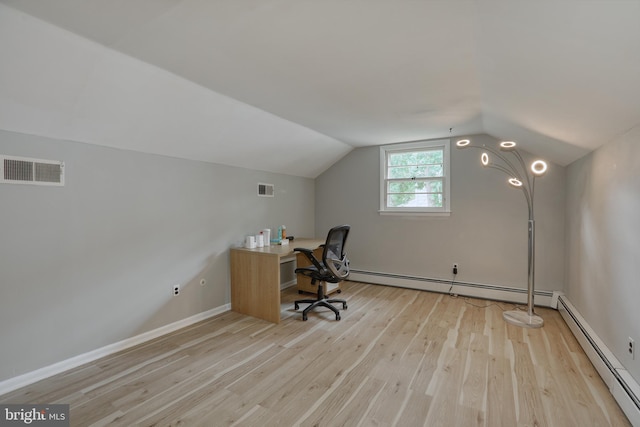 unfurnished office with light wood-type flooring, baseboard heating, and vaulted ceiling