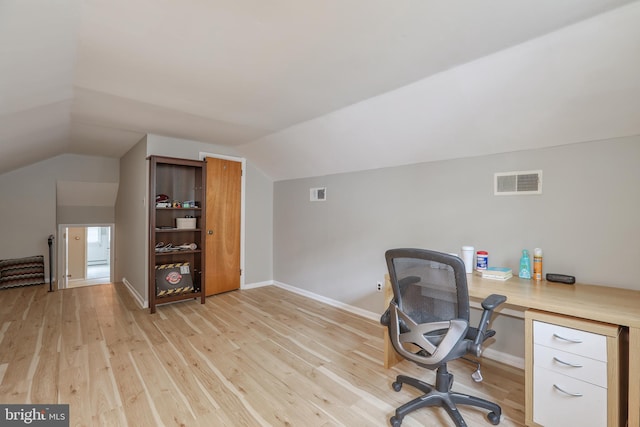 office space with light hardwood / wood-style flooring and lofted ceiling