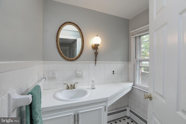 bathroom featuring a baseboard heating unit and vanity