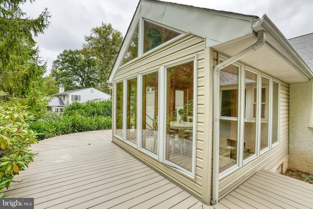 wooden deck with a sunroom