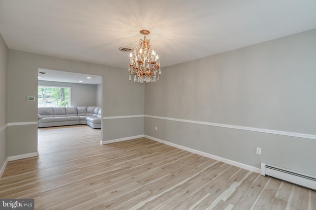 unfurnished dining area with a baseboard heating unit, a notable chandelier, and light hardwood / wood-style floors