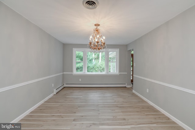 empty room with light wood-type flooring, a chandelier, and a baseboard heating unit