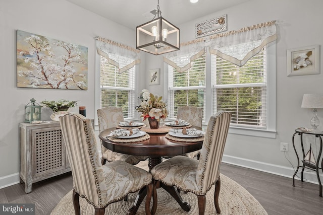 dining room featuring dark hardwood / wood-style floors and a notable chandelier